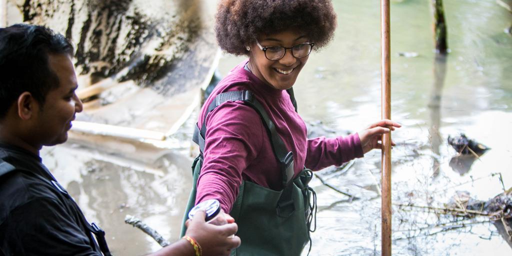 Biological Studies student conducting research in stream